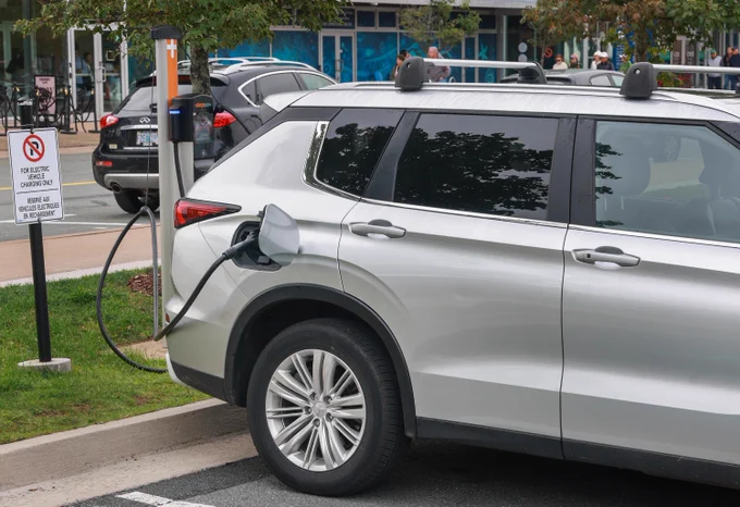 A vehicle plugged in at an electric charging station